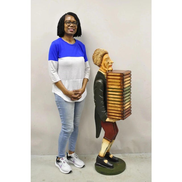 52" Tall Figural Librarian Man Holding Stack of Books Statue Storage Cabinet. Item features 1 swing door, distress painted...