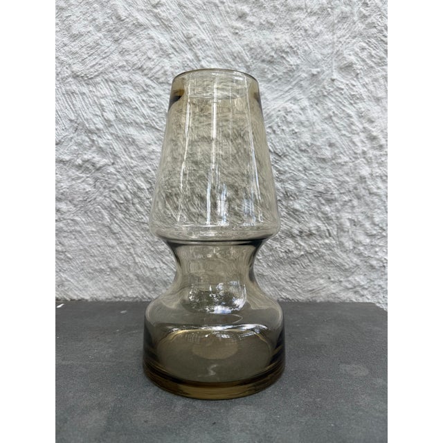 Hand blown tapered top with pinched middle amber colored glass vase. There are no markers marks on the vase that I could...