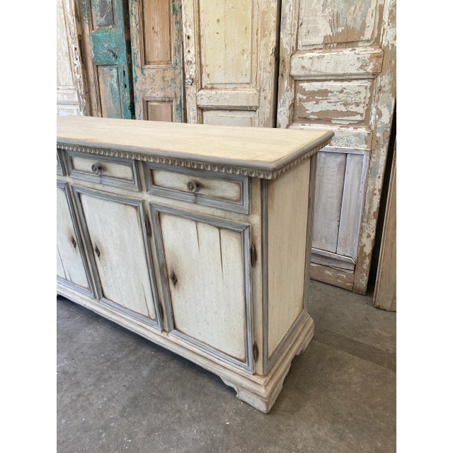 Italian painted buffet credenza, with three drawers over three doors, complete with working key. This piece has a timeless...