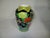 A vintage colorful Japanese hand-painted porcelain vase. It is decorated with peacocks perched on a branch of cherry...