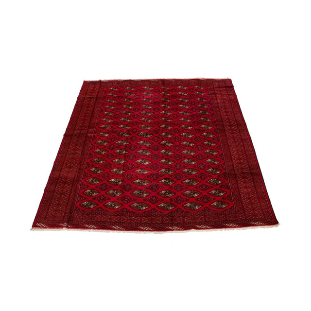 A beautiful vintage Turkmen rug with a red field, and multi-color accents in an all-over geometric design. This rug...