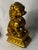 A richly modeled Chinese Buddhist guardian lion, or shishi, seated on a tiered lotus-form pedestal and finished in warm...
