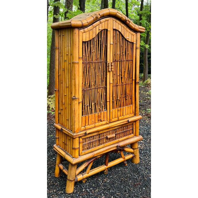 Boho chic vintage palm beach regency bamboo cabinet with drawer. Arched bonnet top with two upper doors with woven reed...