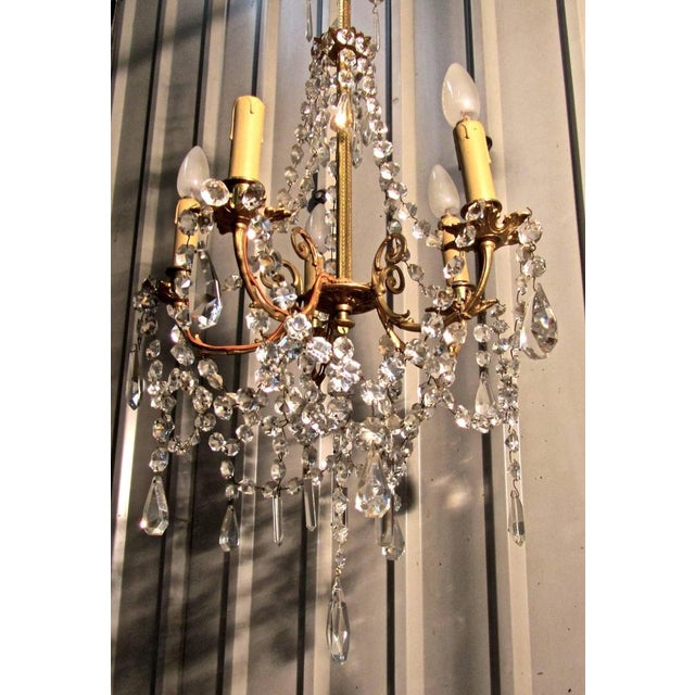 A charming and large French cut glass and brass five branch chandelier. This is an excellent quality piece, the decorated...