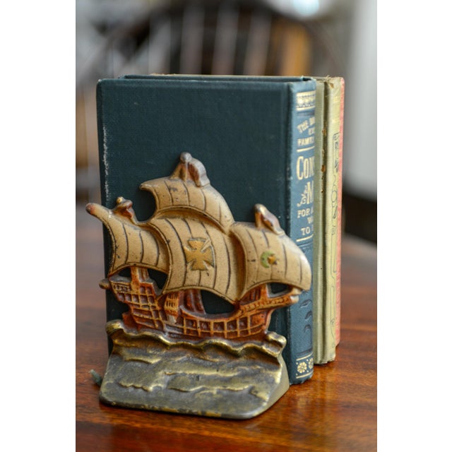Nice painted vintage cast iron bookends. One of the felt bottoms has been replaced and the other side could use an update....