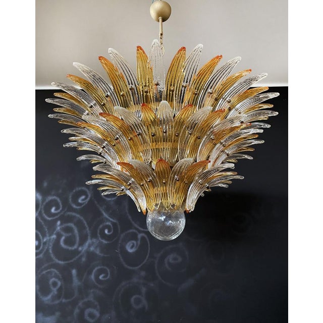 Palmette ceiling light made by 104 Murano clear and amber glasses in a gold metal frame. Murano blown glass in a...