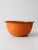 A vintage orange enamelware bowl featuring classic black trim and a timeless utilitarian form. The bold, saturated color...