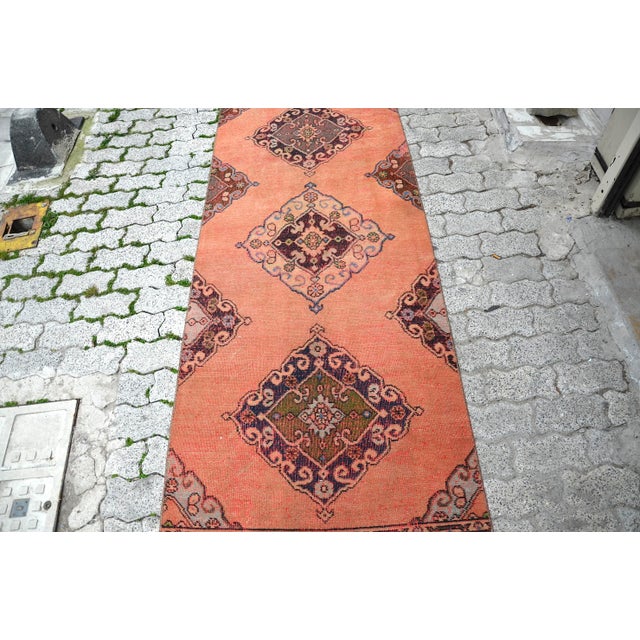 This is a vintage Turkish Oushak rug from the 1960s. The piece was hand-knotted.
