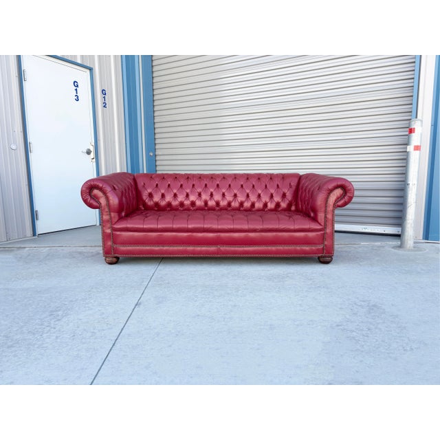 This spectacular vintage Chesterfield sofa embodies classic British elegance with a bold, modern edge. Upholstered in rich...