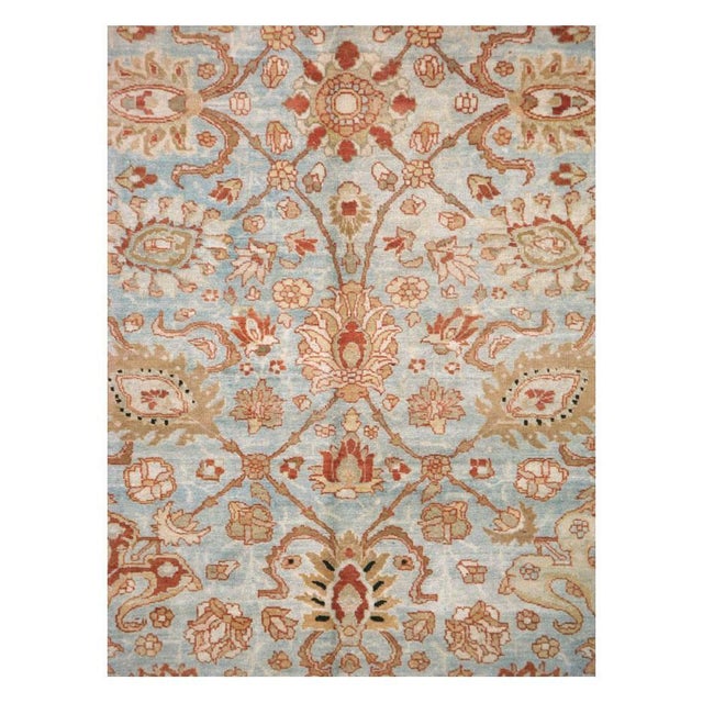 An antique Persian Tabriz room size carpet handmade during the early 20th century with a floral pattern over a light grey...