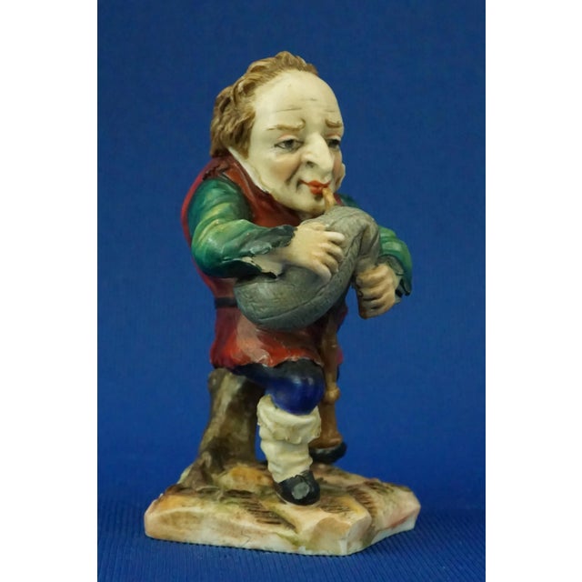 Wonderful figurine depicting a dwarf caramogi bagpiper, in polychrome hard-paste porcelain entirely hand-decorated and...