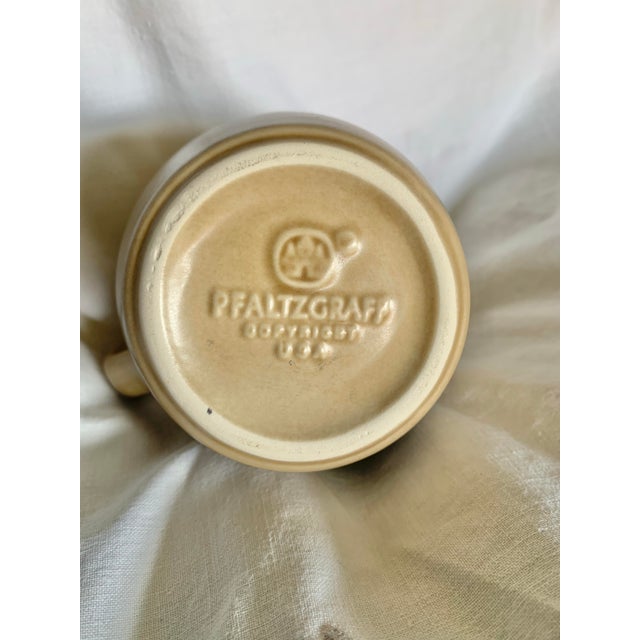 This water pitcher from Pfaltzgraff features a classic Yorktown floral blue pattern against a dark tan background. Is made...