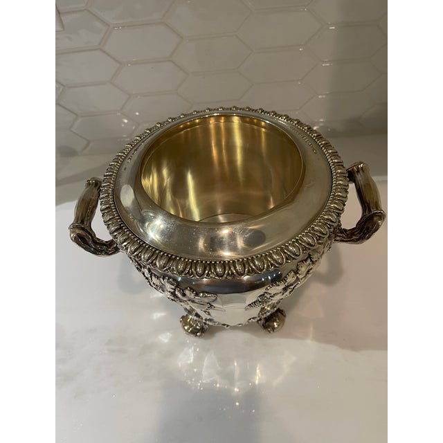 Antique Sheffield silverplate wine or champagne bucket. The bucket is heavy and is embossed with elaborate decorations of...