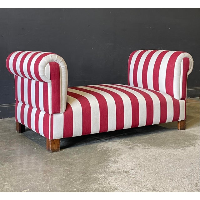 This antique French daybed is freshly upholstered in 100% Belgian linen with a thick Ruby stripe, rotary screen printed in...
