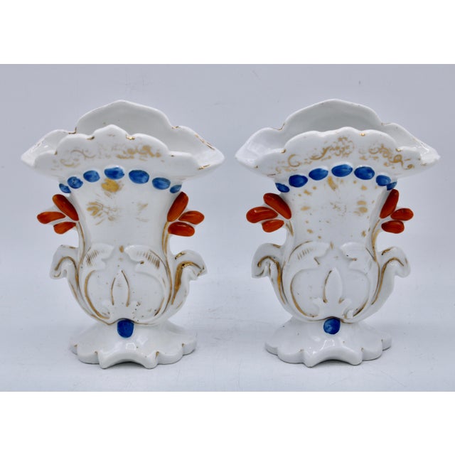 A lovely pair of antique French ceramic Art Nouveau style bud vases. With orange, blue, and golden gilt accents against a...