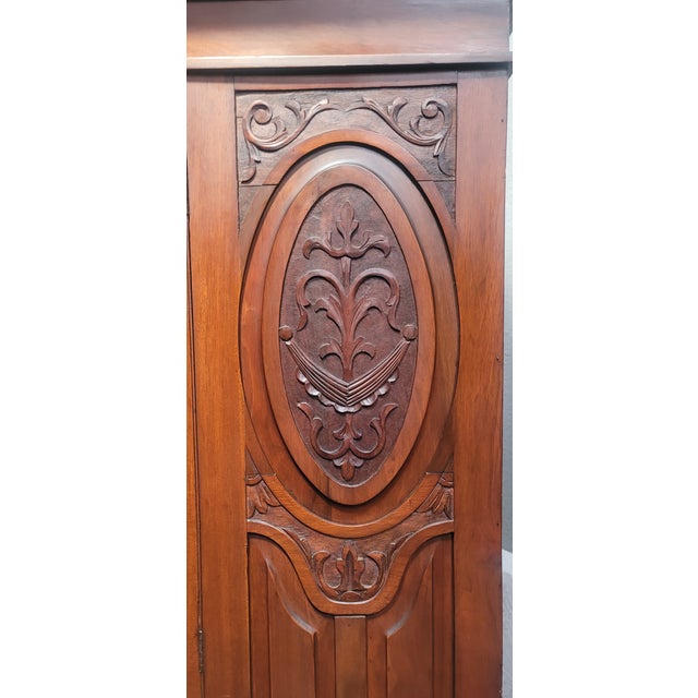 This is an English Armoire from 1900s Edwardian /Victorian Style. It has Art Nouveau Flare and is made of solid walnut....