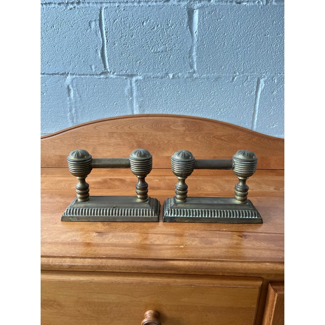 Classic elegance in these brass Fire Dogs or Fire Tool Rests. This is a sophisticated pair of antique fireside tool rests,...