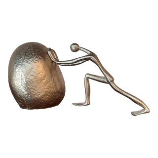 Vintage Brass Man Pushing Rock Sculpture For Sale