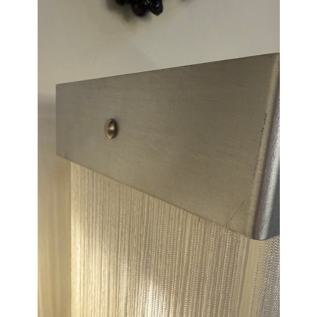 This elegant pair of wall sconces exemplifies the refined modernist language of Massimo Vignelli, combining disciplined...