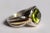 A brilliant 8 carat faceted oval peridot is the star of this stunning ring. The ring itself is a combination of 18K gold...
