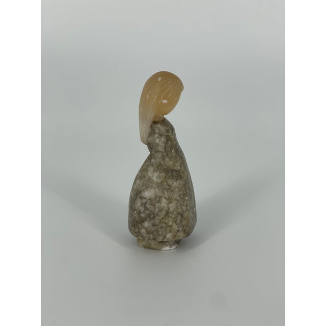 A sweet vintage c. 1980s Russian folk art girl figurine carved sculpture. She is made of brown and grey stone with a...