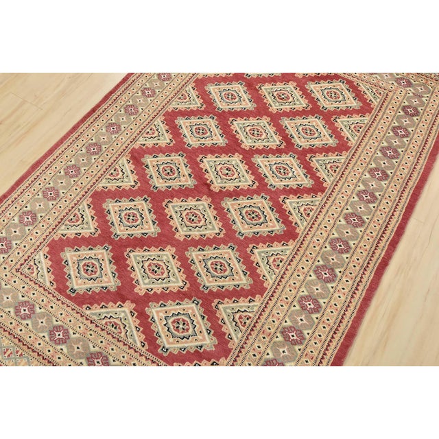 A tribal Bokhara Jaldar rug hand-knotted with an all-wool pile on a cotton foundation. This finely woven oriental rug...