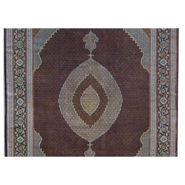 A wonderful early 20th century Persian Tabriz rug with a large central complex medallion with a tightly woven petite all-...