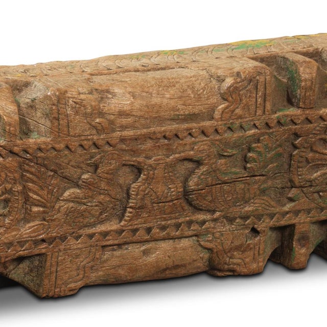 A striking coat rack born from architectural heritage. This carved wooden fragment, salvaged from a mid-20th century Tamil...