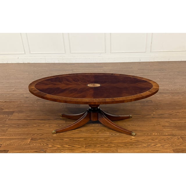 This is a classic oval mahogany cocktail table made in the Leighton Hall shop in Suwanee, Georgia. It features a field of...
