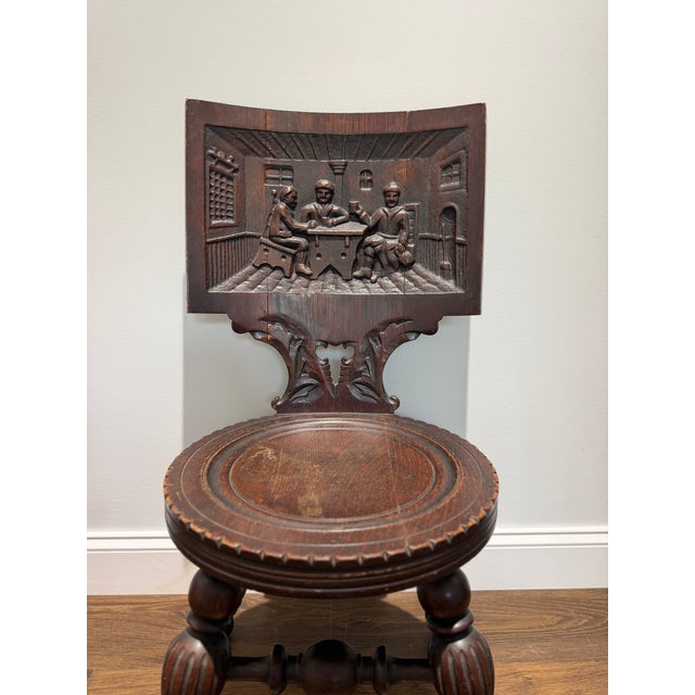 An exceptional antique German Black Forest tavern chair, handcrafted in the early 20th century from richly figured...
