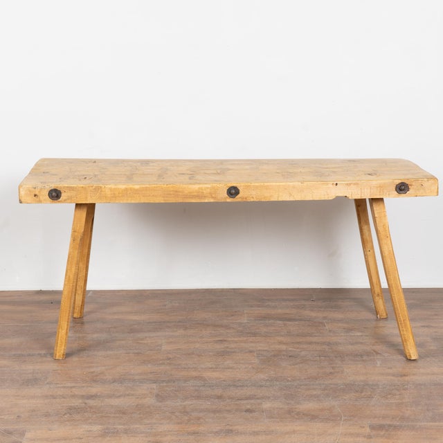This rustic plank top console table with splay peg legs originally served as a work table. Note the top revealing...