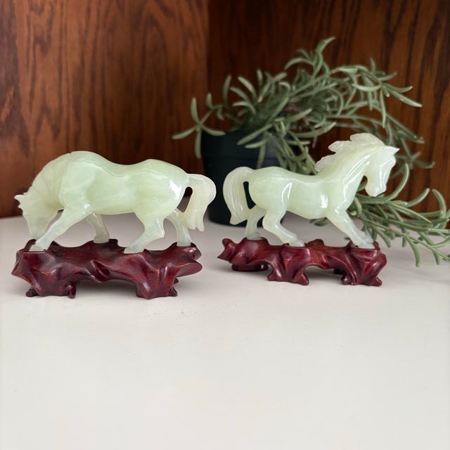 Pair of Jade carved horses on custom wooden bases. Jade carvings have been a significant part of Chinese art and culture...