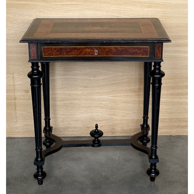 Antique Napoleon III sewing table, circa 1880 The marquetry is made of various woods. A brass feast surrounds the table...