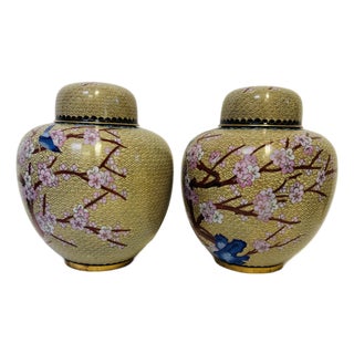 Pair of Vintage Chinese Cloisonné Ginger Jars Featuring Intricate Enameled Bird and Floral Designs on a Patterned Beige Background. For Sale