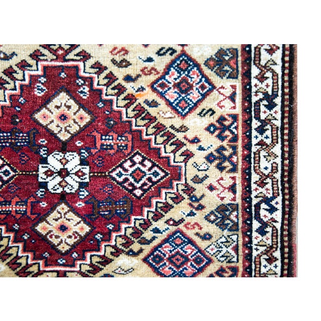 A wonderful early 20th century Persian Afshar rug with a bold tribal pattern with stylized flowers in a diamond medallion...