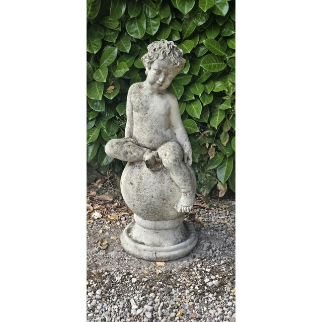 Very pretty stone cherub seated on a ball with socle base, lovely casting . 15" high 10" diameter