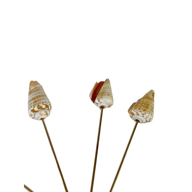 Set of 12 vintage conch Shell charcuterie skewers with brass sticks. Each shell is slightly different some are at a slight...