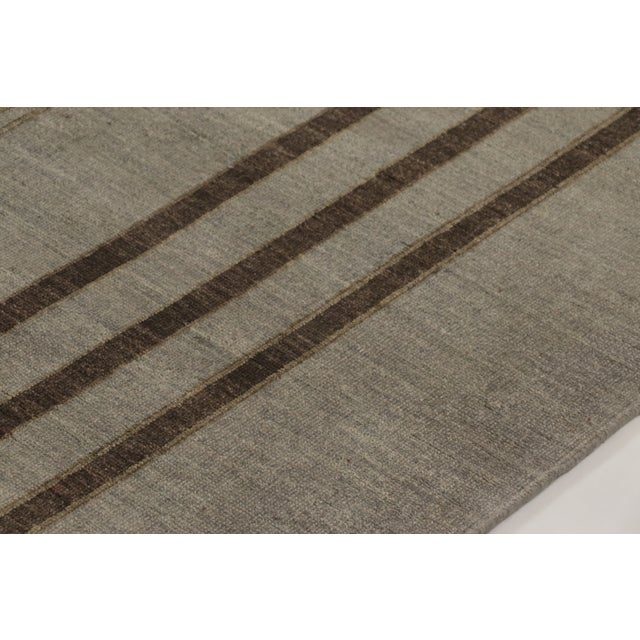 Hand-knotted in wool, this 9x12 Art Deco rug features a refined geometric design in soft taupe and espresso brown....