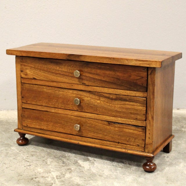 Miniature model of a chest of drawers Made of solid walnut Second half of the 19th century Origin: Italy Dimensions: width...