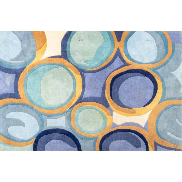 Momeni Blue New Wave Wool Rug, with circular pattern, "Momeni" label to underside. 8' L x 5' 2" W. Provenance: From an...