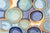 Momeni Blue New Wave Wool Rug, with circular pattern, "Momeni" label to underside. 8' L x 5' 2" W. Provenance: From an...