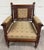This is a stunning antique Victorian Eastlake library chair, lounge chair, or armchair crafted in walnut, featuring carved...