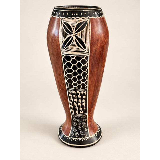 An impressive vintage hand-carved African earthenware pottery vessel featuring striking geometric sgraffito details. Fired...
