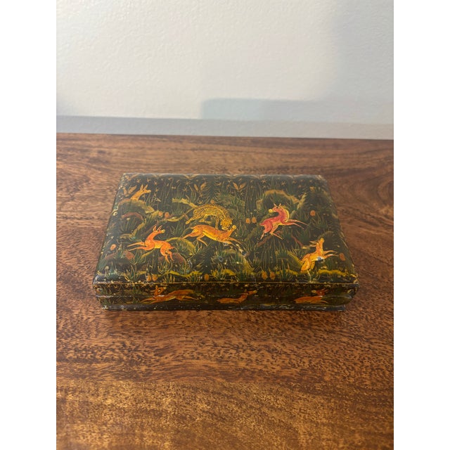 A beautifully handcrafted and hand painted lacquered decorative box dating to the mid-20th century. Finished with a rich...