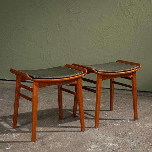 This pair of Ottomans was produced in Denmark during the 1960s by P. Jensen, with one stool retaining the original P....