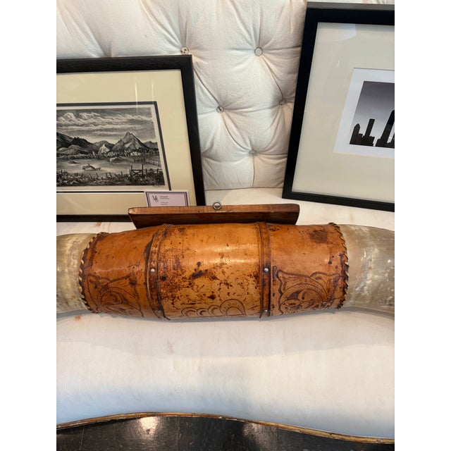 An impressive pair of oversized Texas longhorns mounted with a hand tool;ed leather centerpiece. Striking scale and...