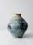 A vintage studio pottery vase, signed by the artist, with a large, dynamic form and a subtle ridged surface. The glaze...