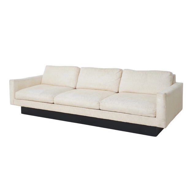 A classic 1970s silhouette with tailored restraint. This three-seat sofa features its original ivory tweed upholstery and...