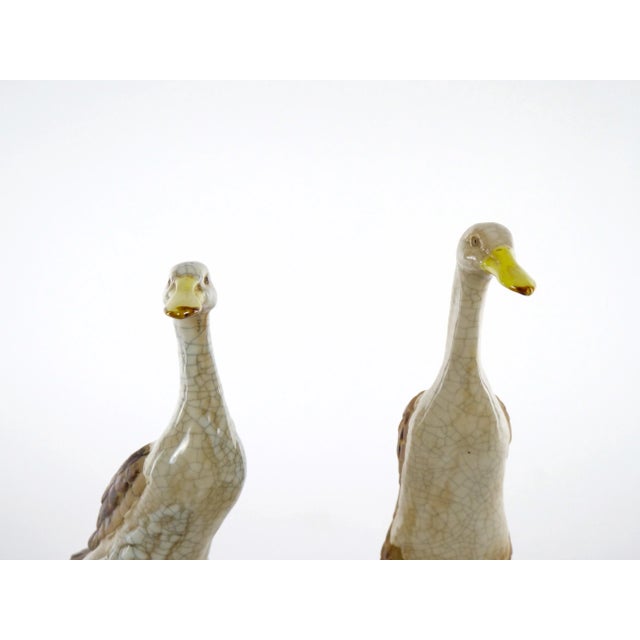 Beautiful English porcelain / terracotta hand painted and glazed decorated pair of decorative duck statues. This stunning...