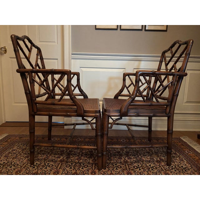 Pair of matching beautiful faux bamboo arm chairs. Elegant in a foyer or at your dining room table. Sourced from a...